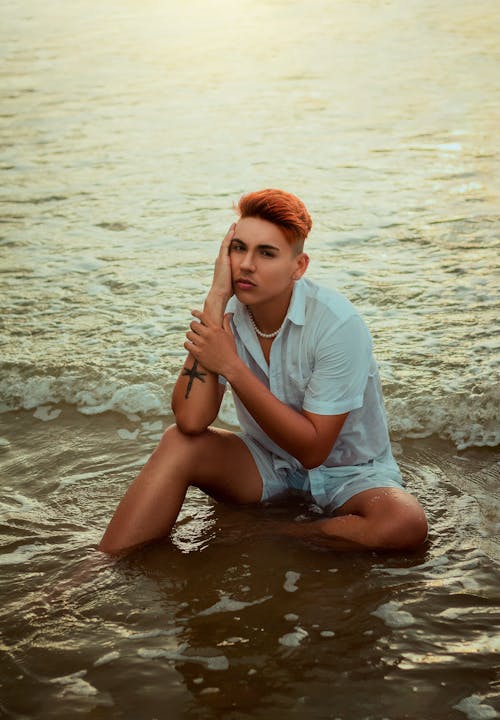 Person with Dyed Hair Sitting and Posing in Water