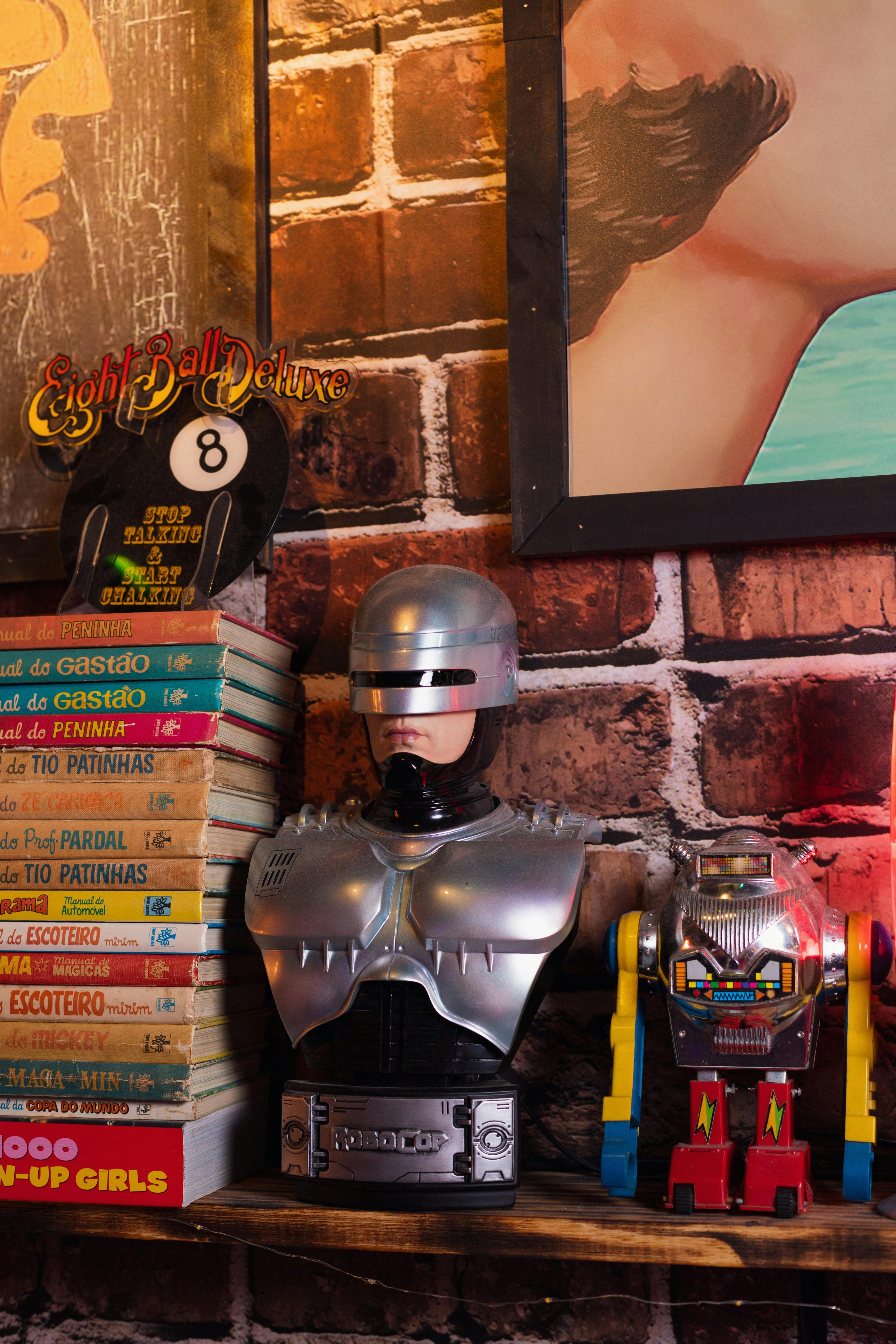 Vintage robot toys on a shelf with comic books and art, illustrating retro decor.