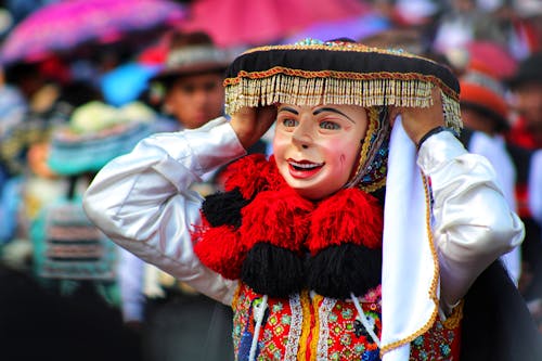 A Person in a Costume and a Mask during a Traditional Celebration 