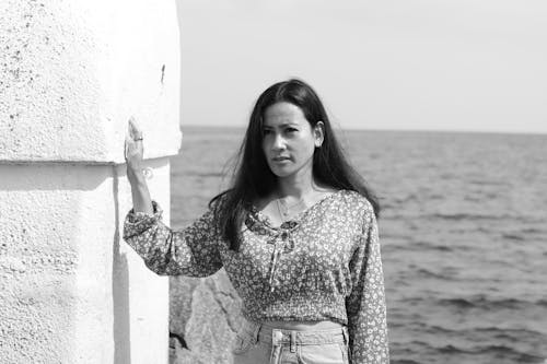 Black and White Portrait of a Young Woman with Sea in the Background 