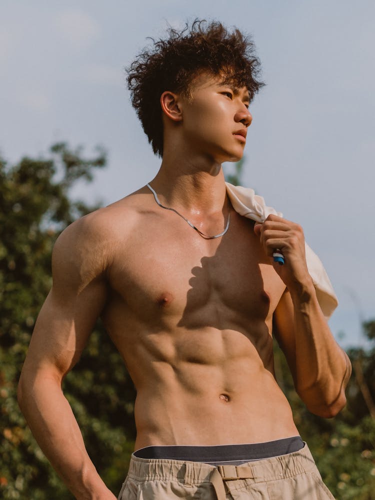 Young Shirtless Man Posing Outside 