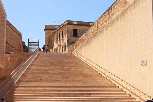 Free Stone steps ascending to historic buildings in Valletta, Malta on a sunny day. Stock Photo