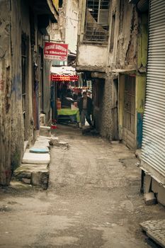 A deserted narrow alleyway in Ankara showcasing urban decay and rustic textures.