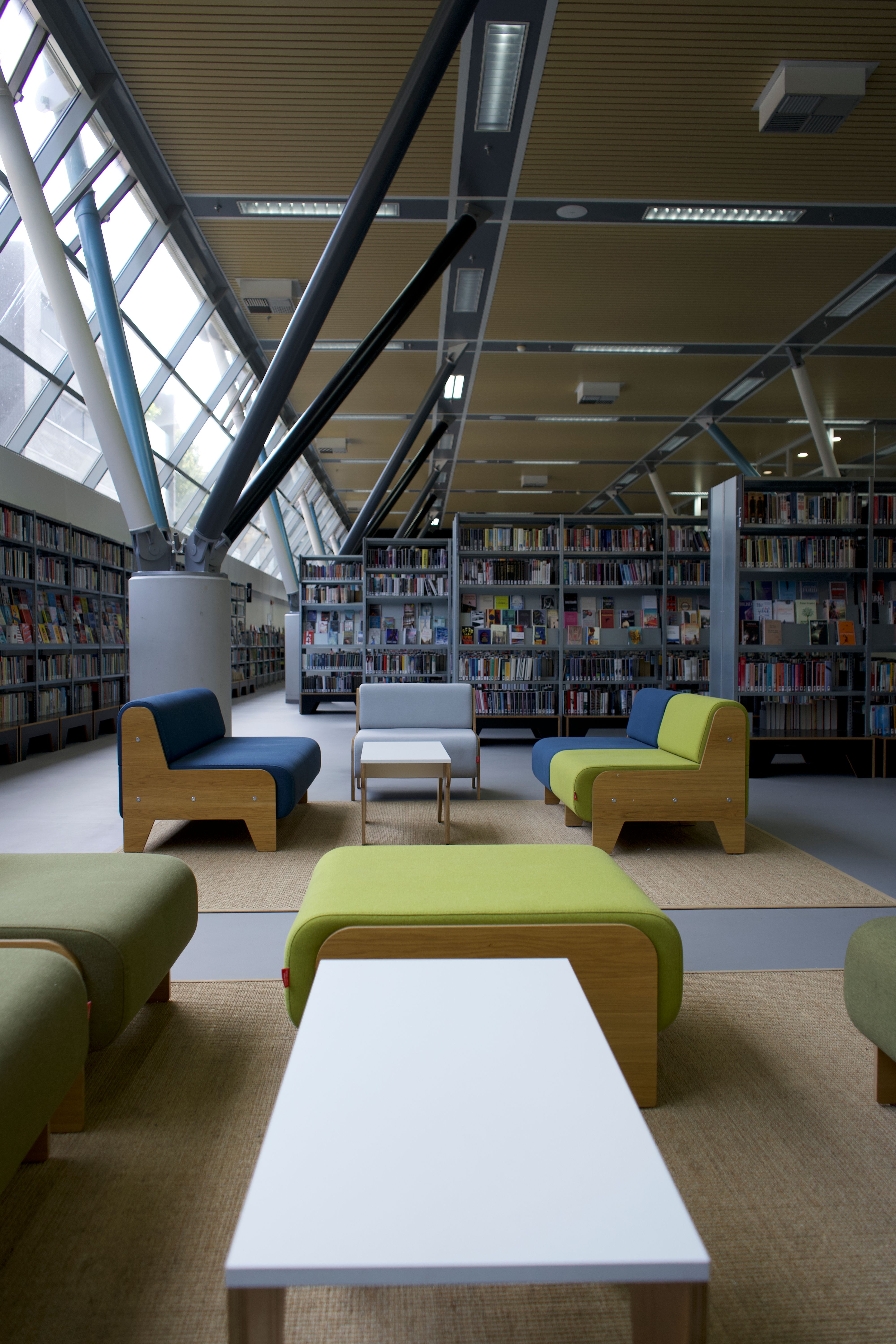 Interior of a library featuring a cozy sitting area with carpets.