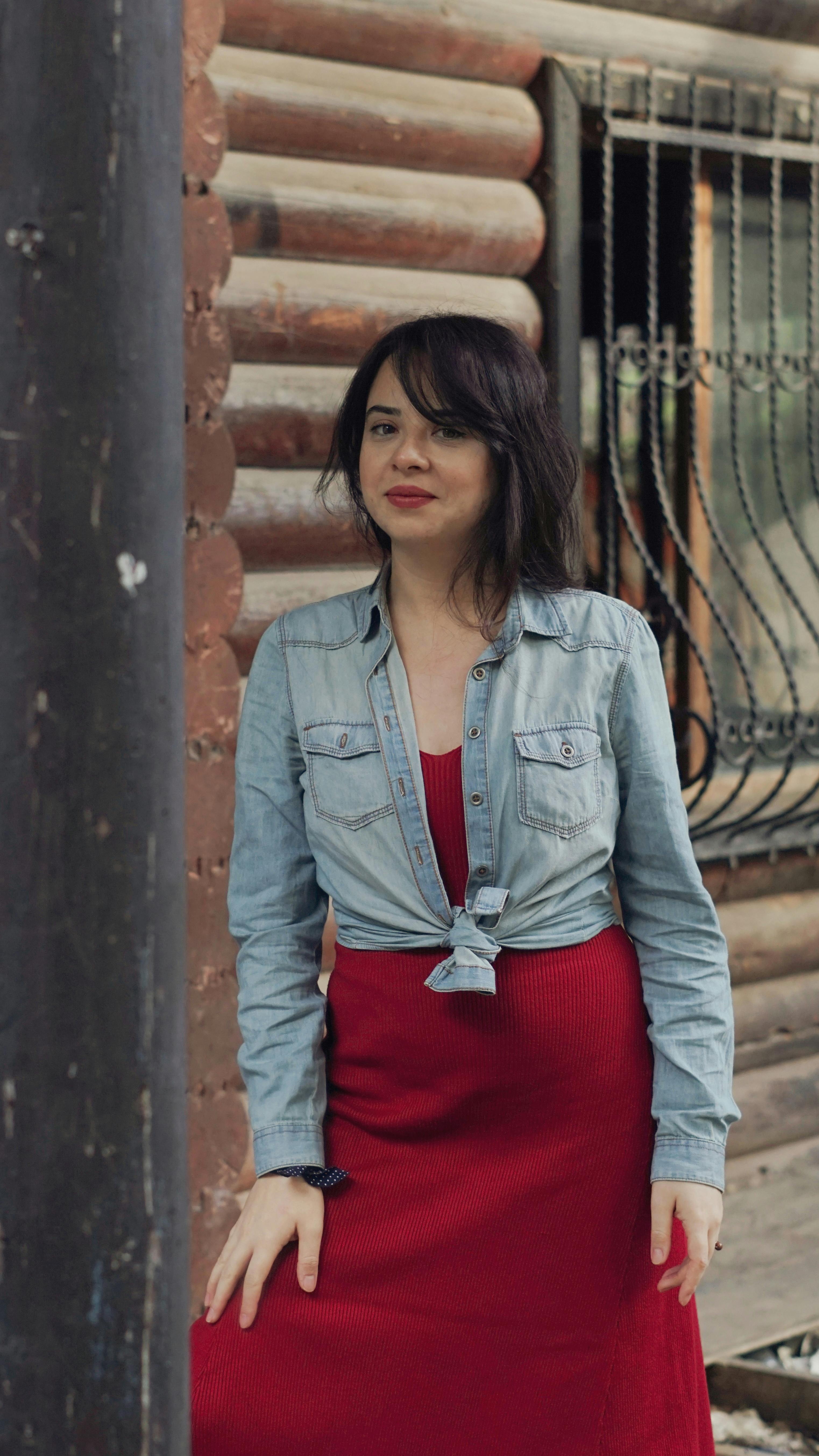 A woman in a red pleated skirt and denim jacket photo – Free Pants Image on  Unsplash