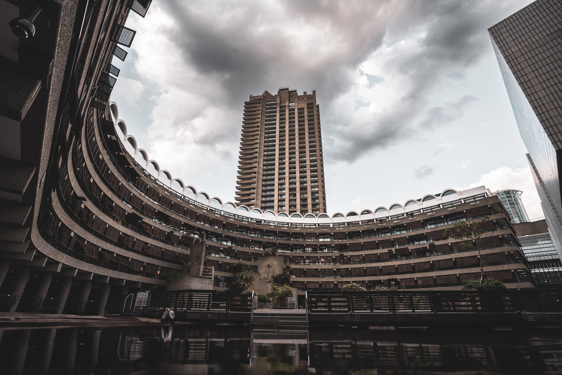 A striking view of the Barbican Centre's unique architecture in London, UK under dramatic skies.