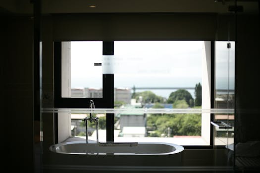 Luxurious bathroom with a modern bathtub overlooking a scenic view through large windows.