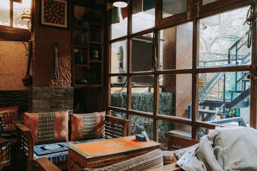 Chairs with Cushions near Table by Windows