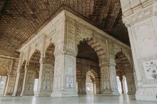 Free Explore the ornate columns and arches of an ancient Mughal building in Delhi, India. Stock Photo
