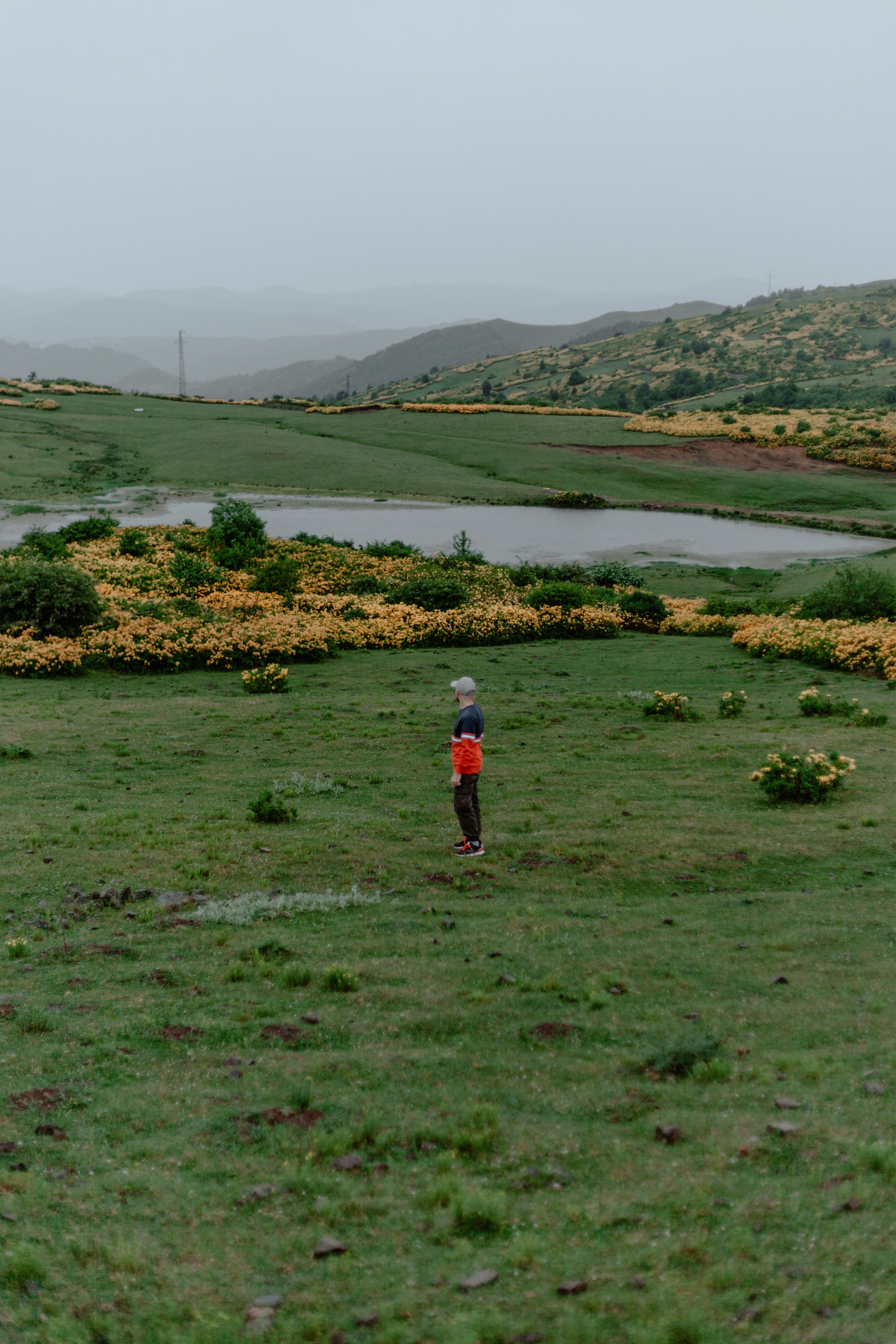 Man Standing on Grassland in Countryside · Free Stock Photo