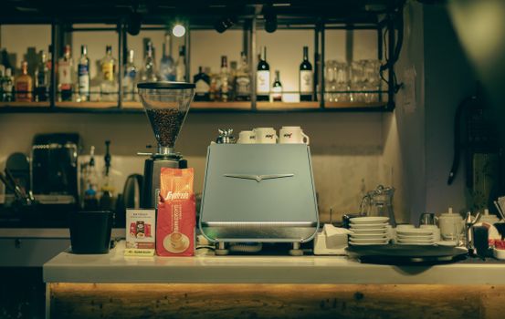 A warm and cozy cafe interior showcasing an espresso machine and bar area with coffee supplies.