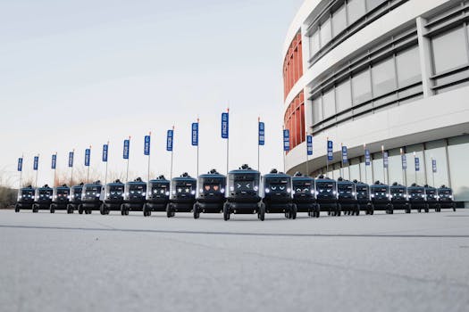 A fleet of delivery robots aligned outside a modern building, illustrating futuristic technology.