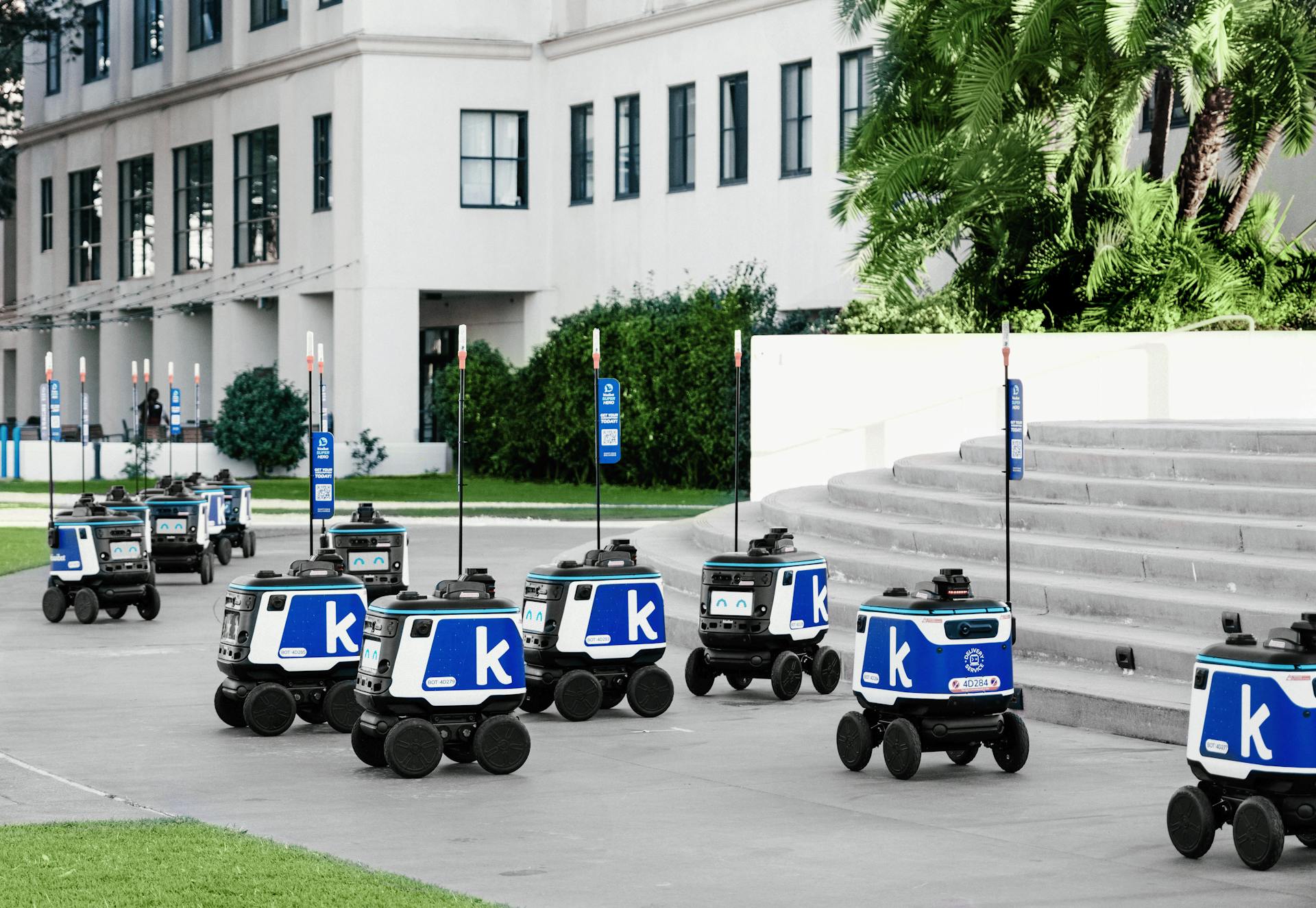 Futuristic autonomous robots delivering packages in an urban setting, showcasing modern technology.