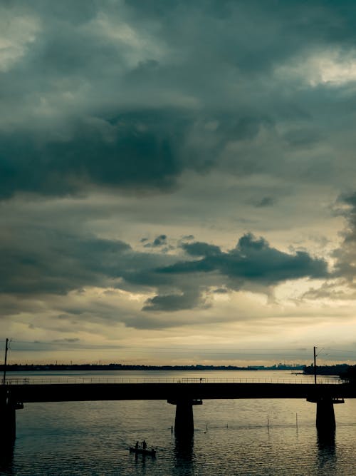 Clouds over Bridge on River
