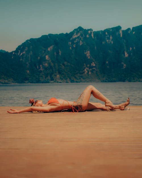 Woman in Bikini Lying Down on Beach