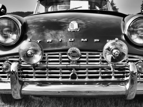 Close-up front view of a vintage Triumph TR3 car, captured in black and white.