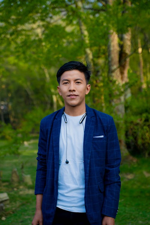 Young Man in a Blazer Standing in the Forest 