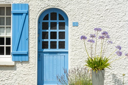Exterior of a House with Blue Door and Blue Window Shutters