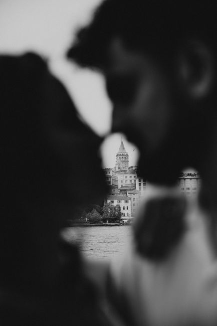 A moody black and white photo featuring a couple's silhouette with the iconic Galata Tower in Istanbul.