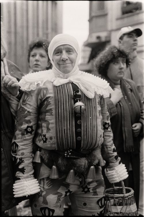 Free Black and white photo of a festive street parade featuring a man in traditional costume. Stock Photo