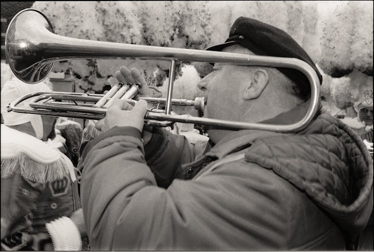 Man In Jacket Playing Trumpet