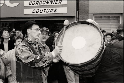 Man Playing on Drum in Black and White