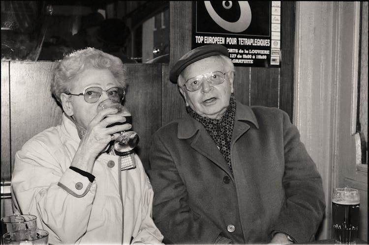 Old Photograph Of An Elderly Couple In The Bar Drinking Beer