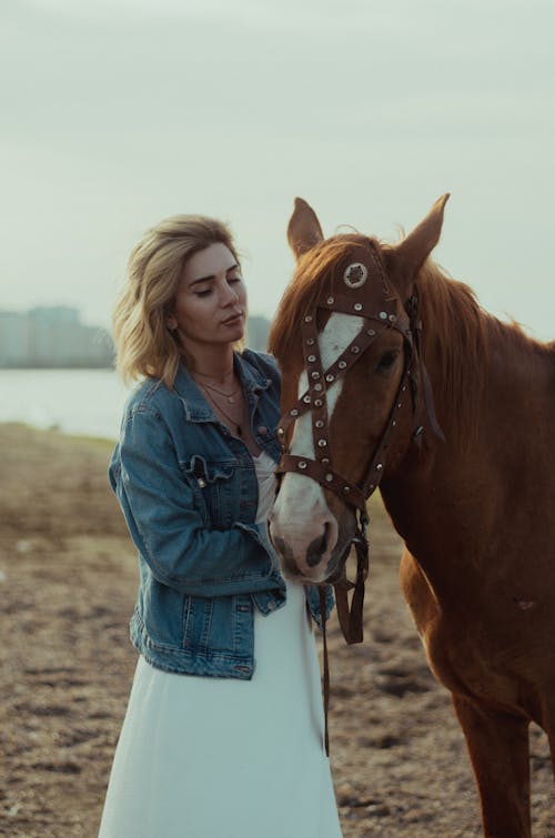 Woman in Jean Jacket Posing with Horse