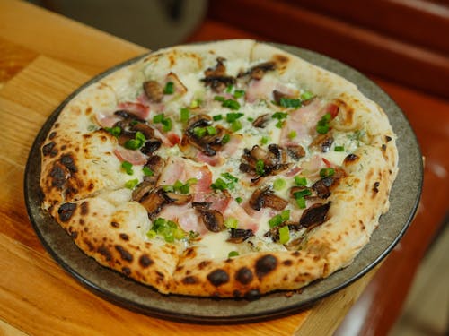 An Italian Style Pizza with Ham and Mushrooms 