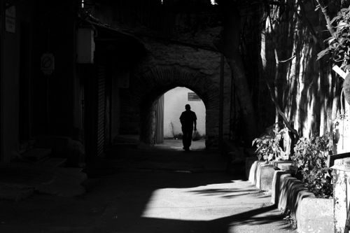 Free A moody black and white silhouette of a person walking through an alley in Istanbul, Türkiye, capturing urban darkness. Stock Photo