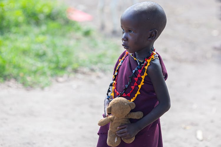 Boy Standing With Teddy Bear