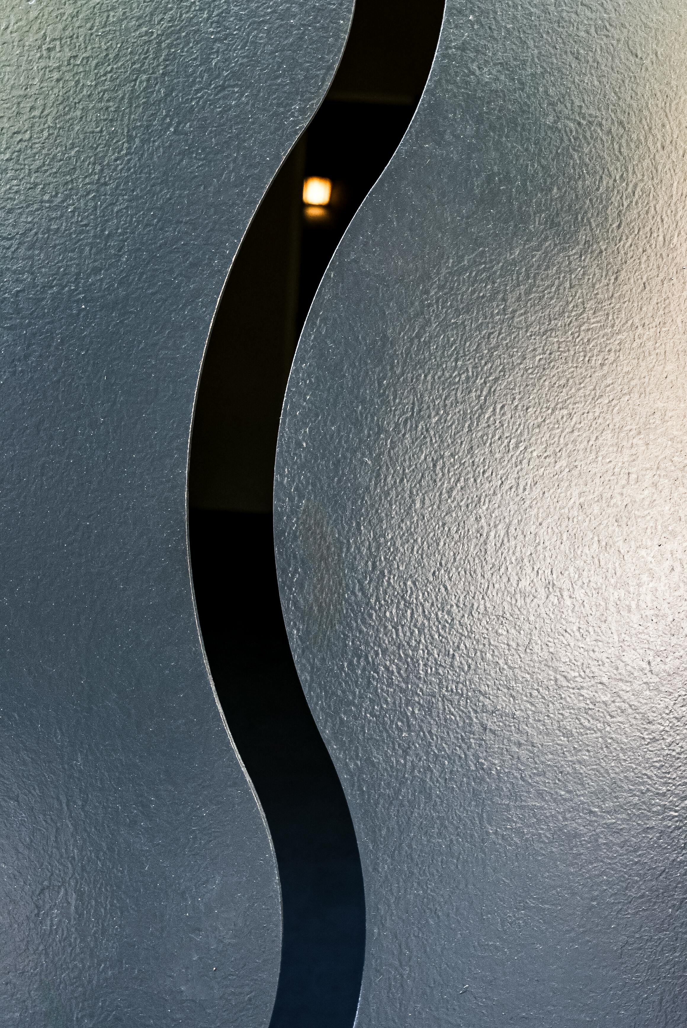 Free Artistic close-up of a gray, wavy texture, emphasizing shadows and light. Stock Photo