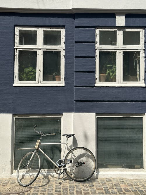 Bicycle near Sunlit, Blue Building Wall