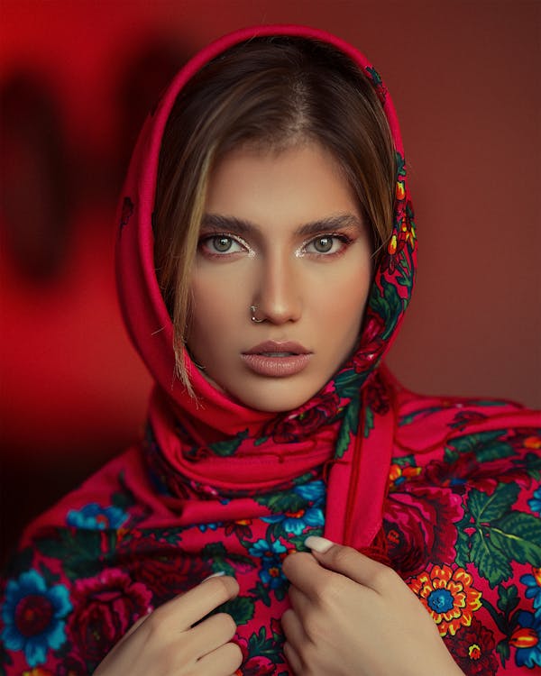 A beautiful woman in a red scarf posing for a photo · Free Stock Photo