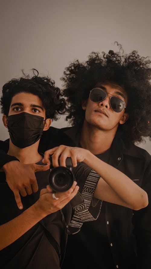 Portrait of Photographers Dressed in Black Holding Camera