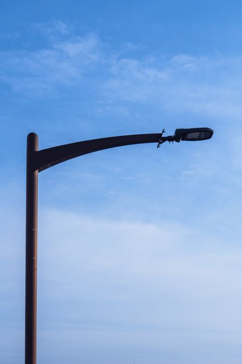 Free A sleek street lamp stands tall against a bright blue sky in Toyokawa, Japan. Stock Photo