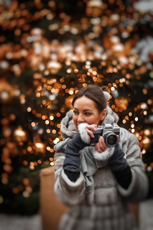 Woman Holding Camera in Selective Focus Photography