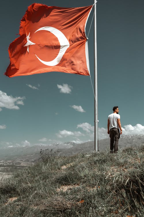 Man Standing on Hill with Turkish Flag