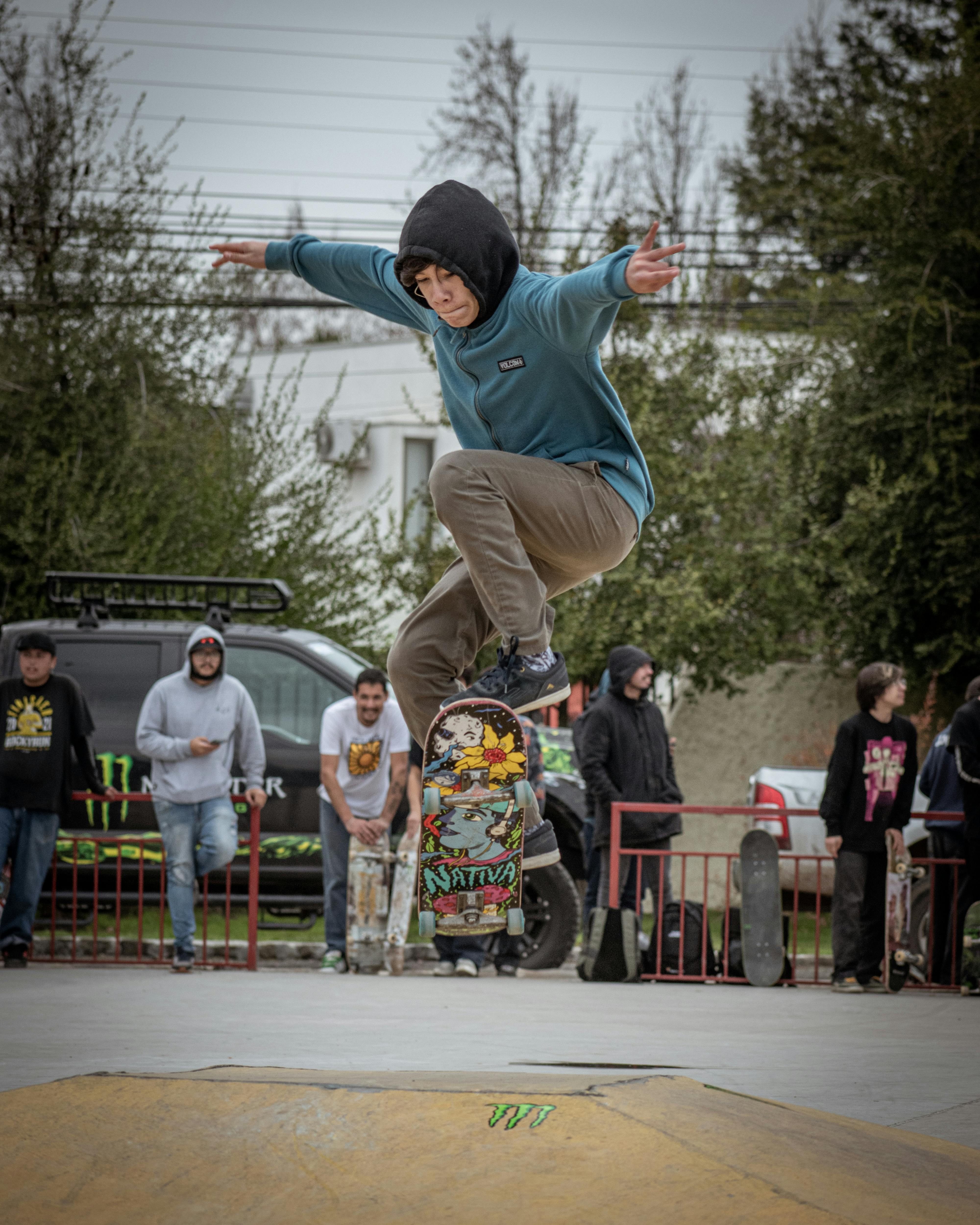 Young man performing skateboard trick in urban skatepark. Dynamic action and street culture.