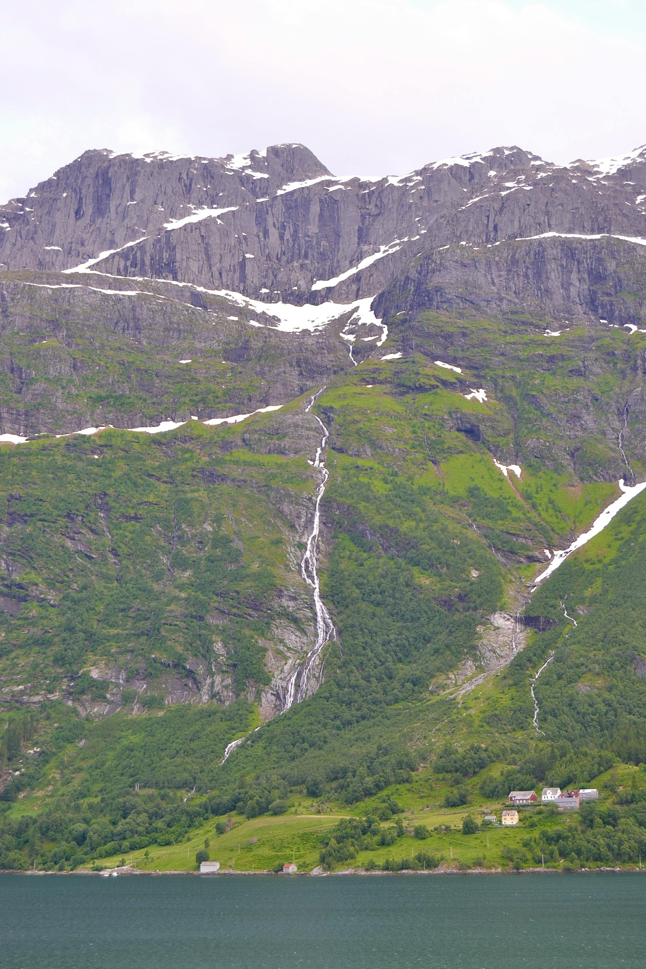 Prescription Goggle Inserts - Stunning view of snow-capped mountains and lush greenery with cascading waterfalls.