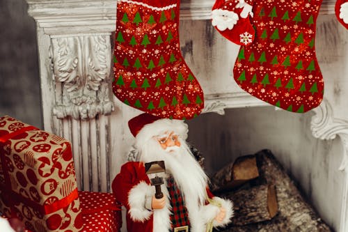 Santa Claus Figurine Standing Near Fireplace