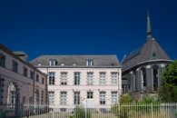 A historic French building with traditional architecture under a bright summer sky.
