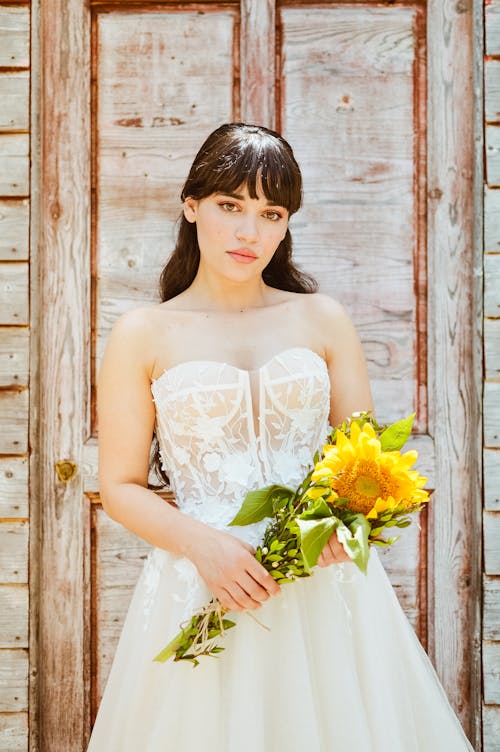 A Bride Posing Against Wooden Wall