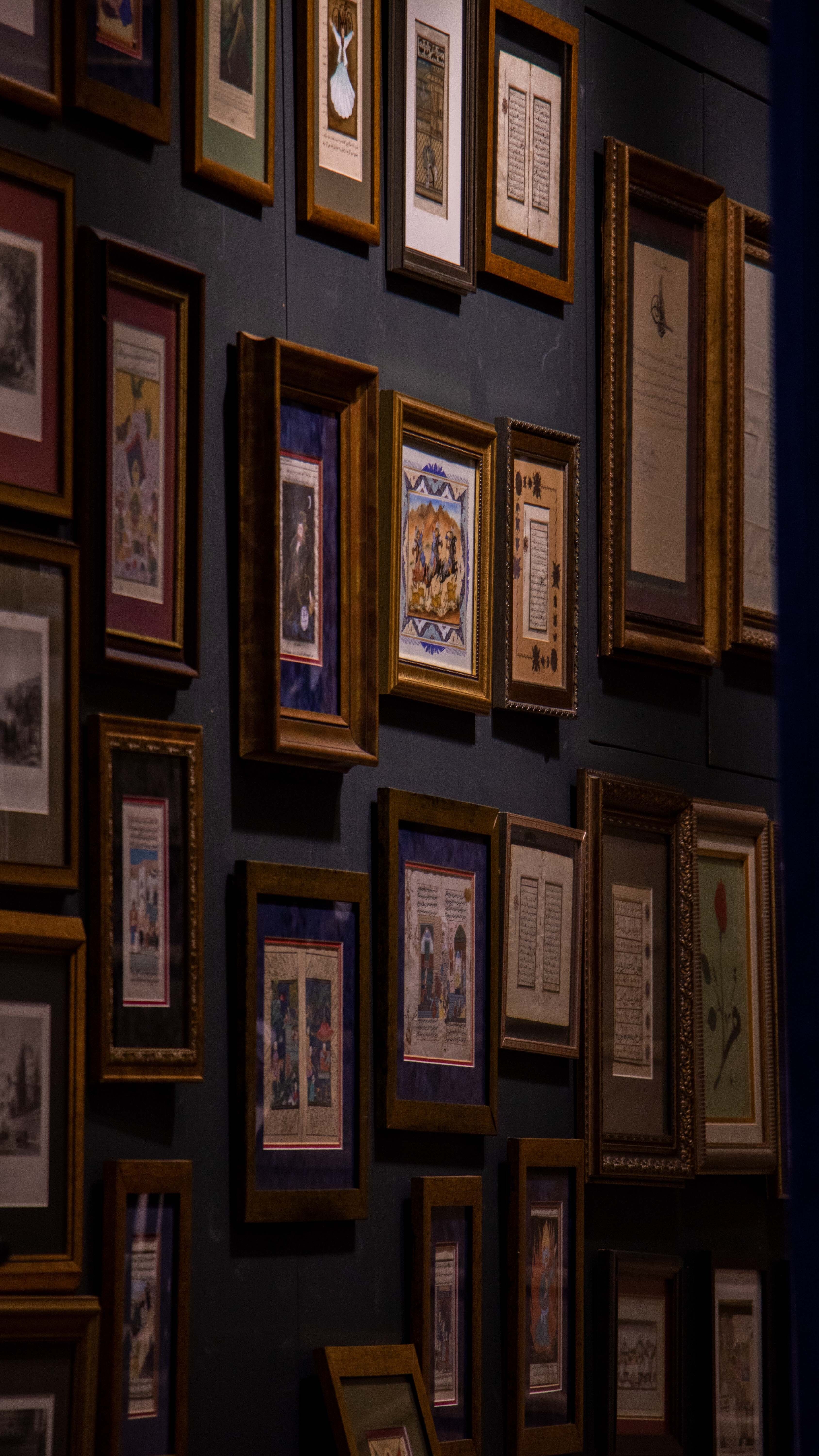 A collection of framed medieval manuscripts on display in an Istanbul museum.