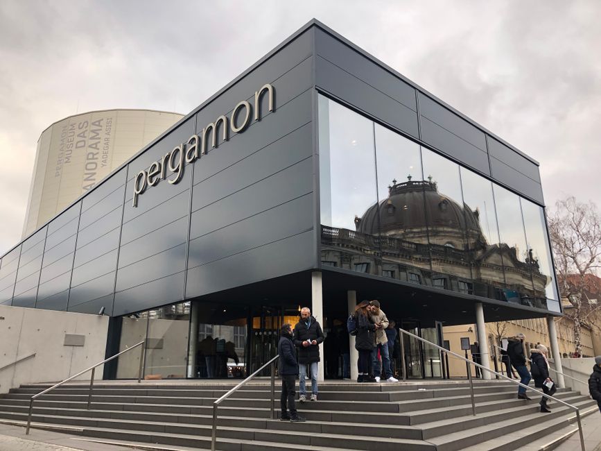 Exterior view of the Pergamon Museum entrance in Berlin, Germany with visitors.