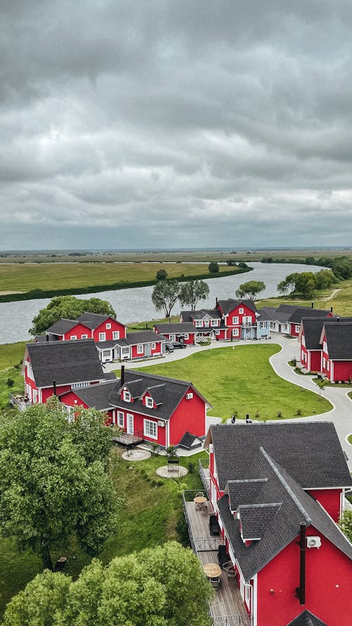 Clouds over Red Houses in Village near River