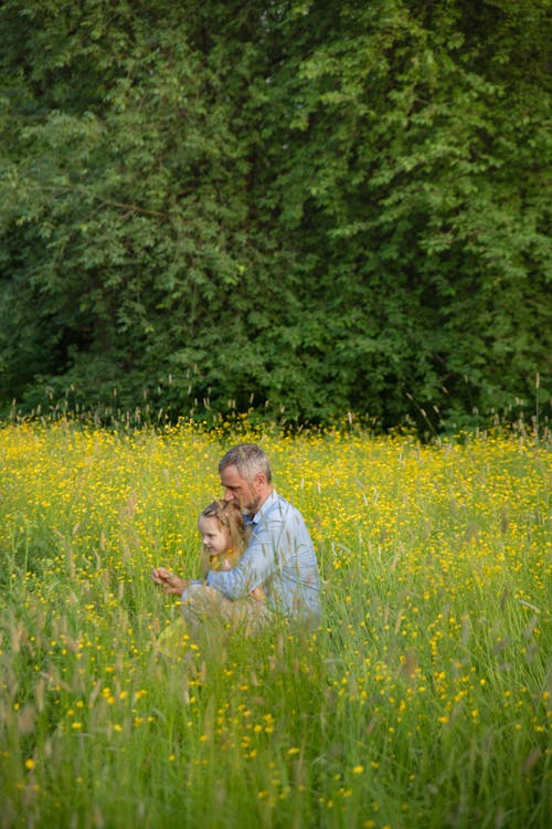 Man with His Daughter on a Meadow 