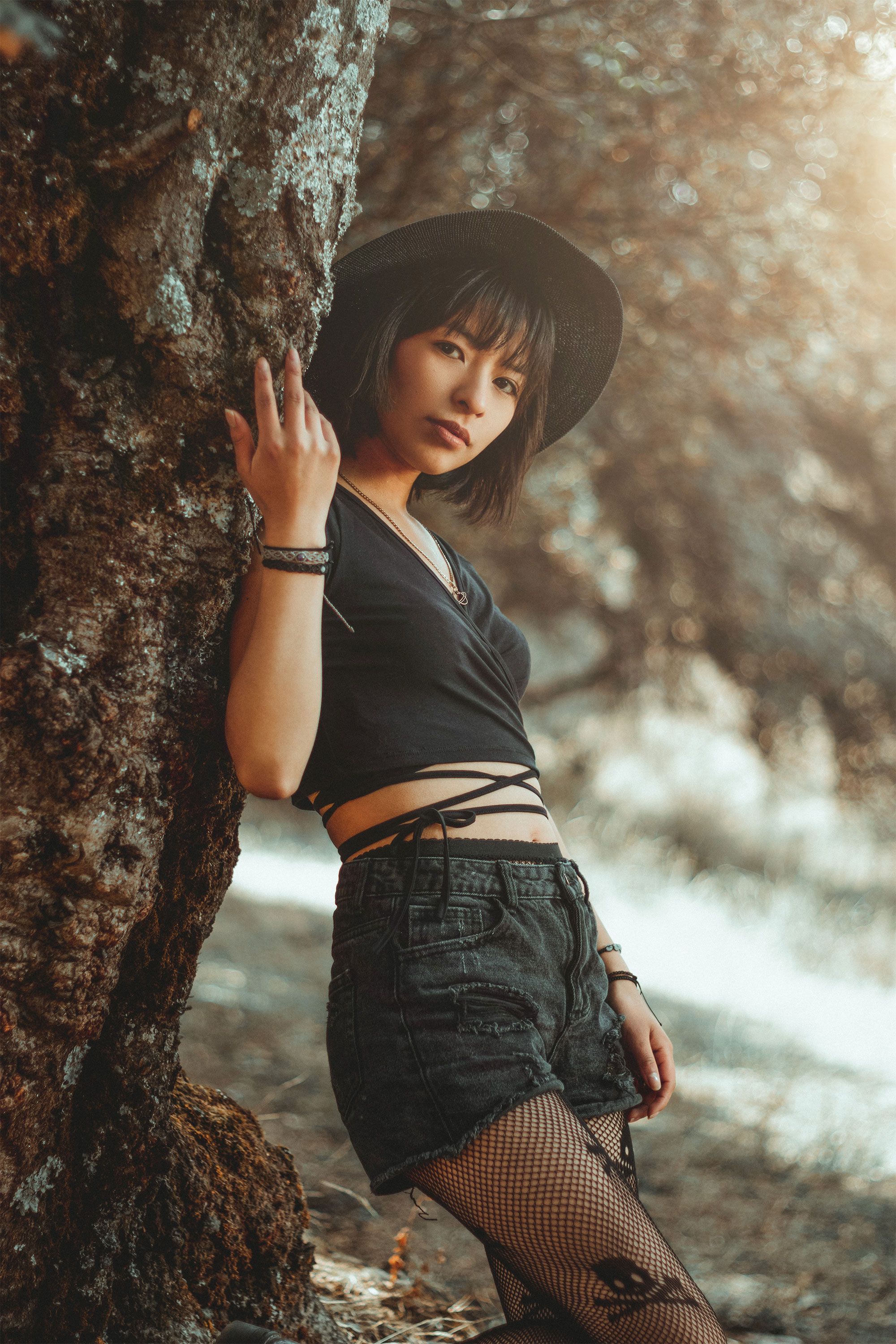 Woman Posing Among Trees in Sunlight · Free Stock Photo