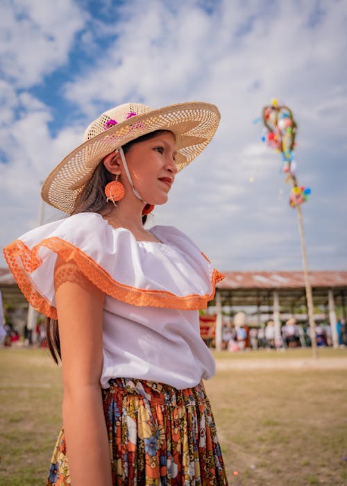 Woman in Hat and Traditional Clothing