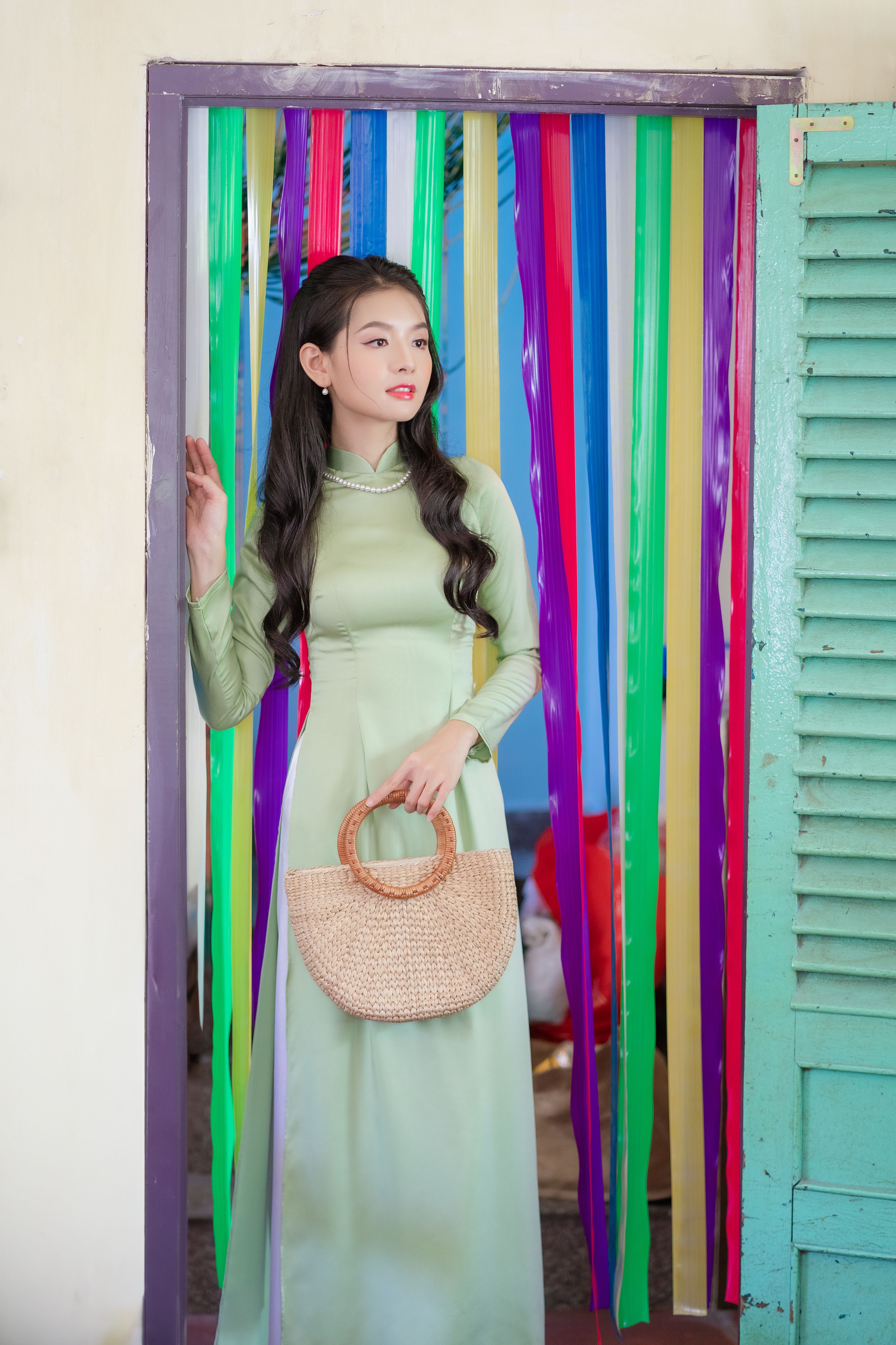Woman in Green Dress Standing in Colorful Doorway · Free Stock Photo